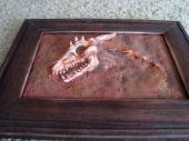 Dragon skull fossil sculpture in a frame, bottom view