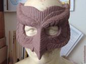 Owl mask sculpture in progress with feather detail