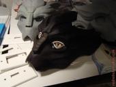 Female turian mask with eye plates, and other faceplates in the background