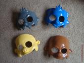 Four partially painted masks - Itchy, Scratchy, Chief Wiggum, and Apu