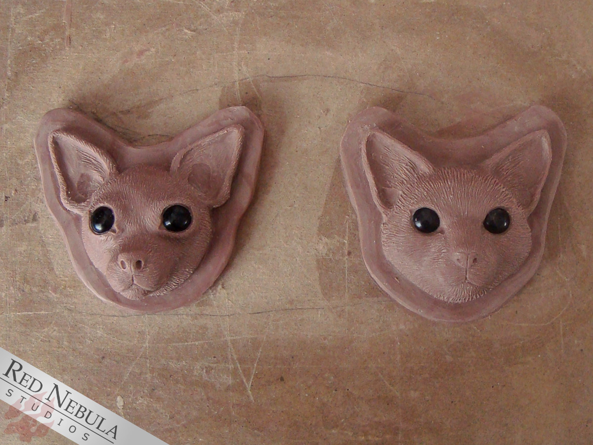 Cat and chihuahua face sculptures